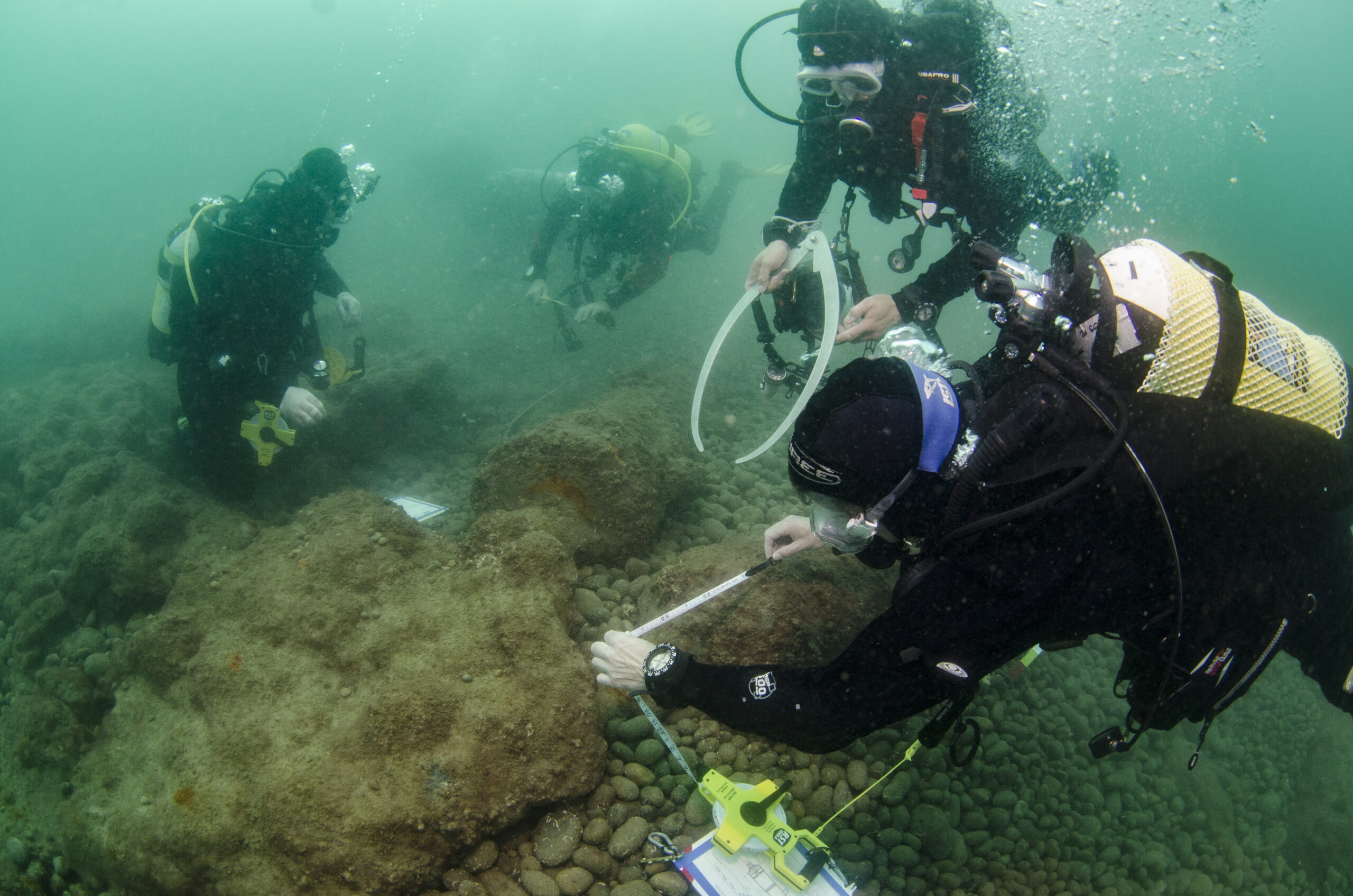 divers measuring a cannon at a chesil beach protected wreck site