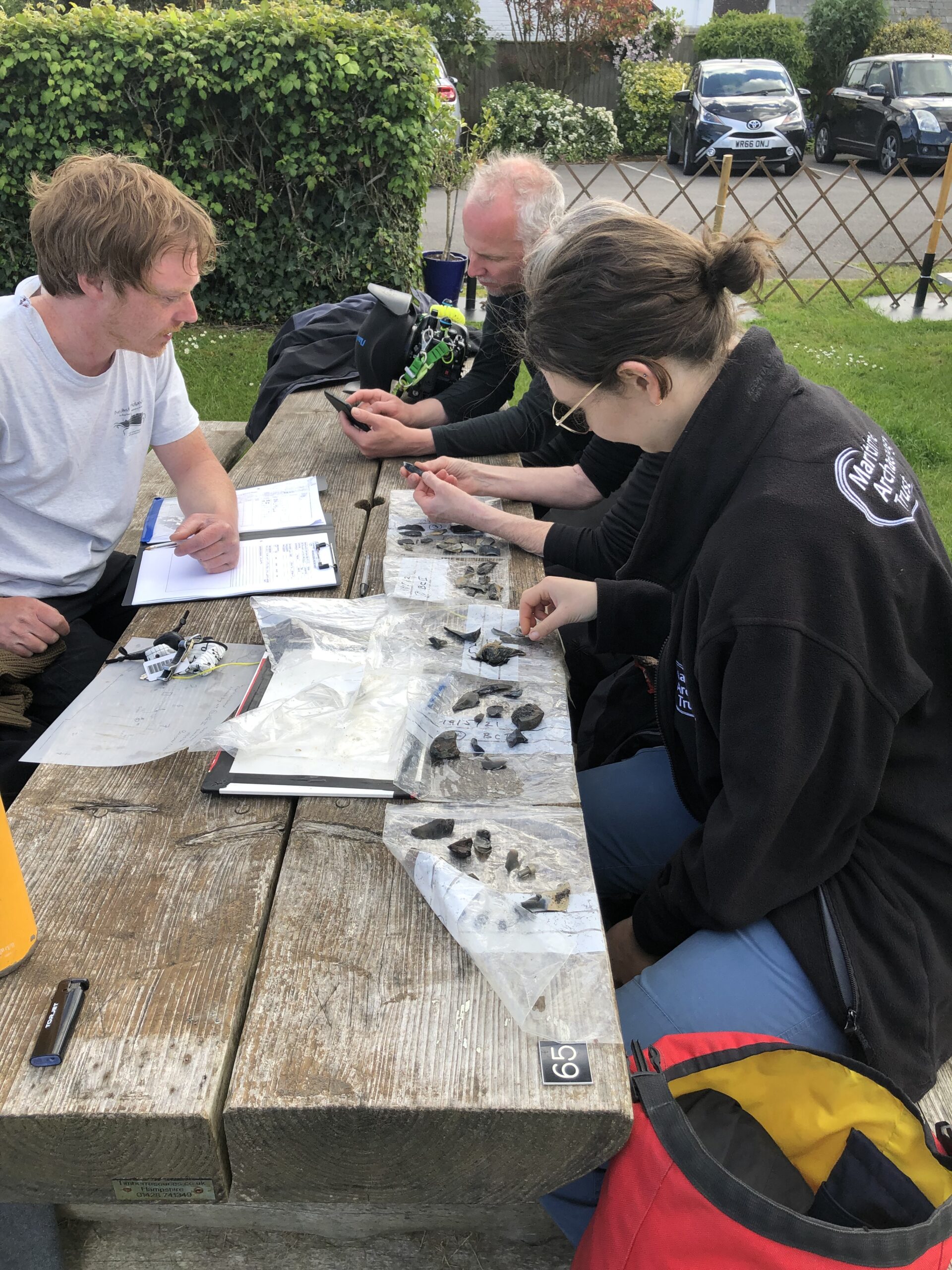 Bouldnor Cliff team examining artefacts