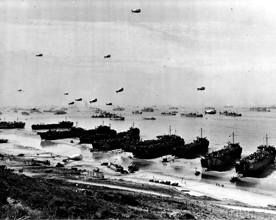LST's discharging cargo onto Omaha Beach at low tide, first few days after D-Day, June 1944