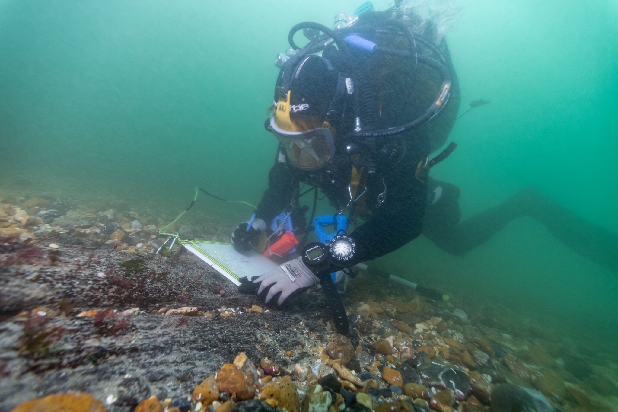 A diver writing on a slate underwater